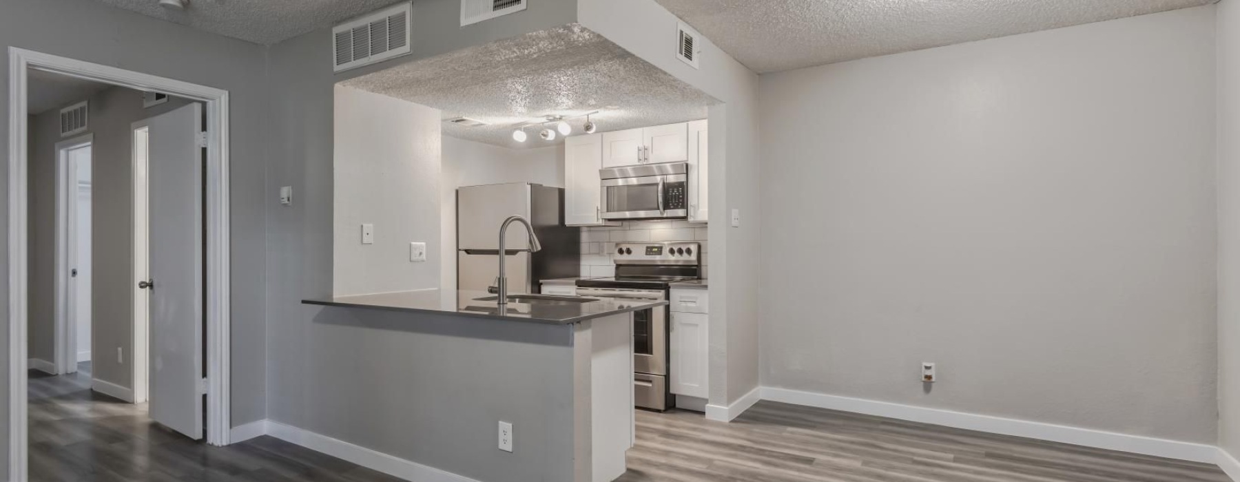 well lit kitchen next to dining area