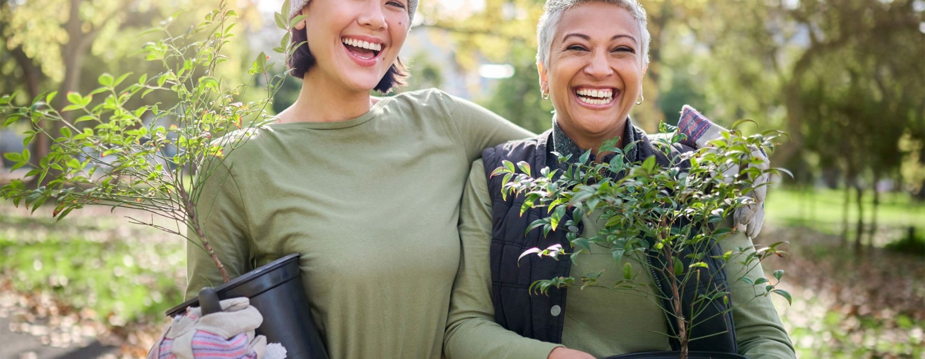 a couple of women holding plants