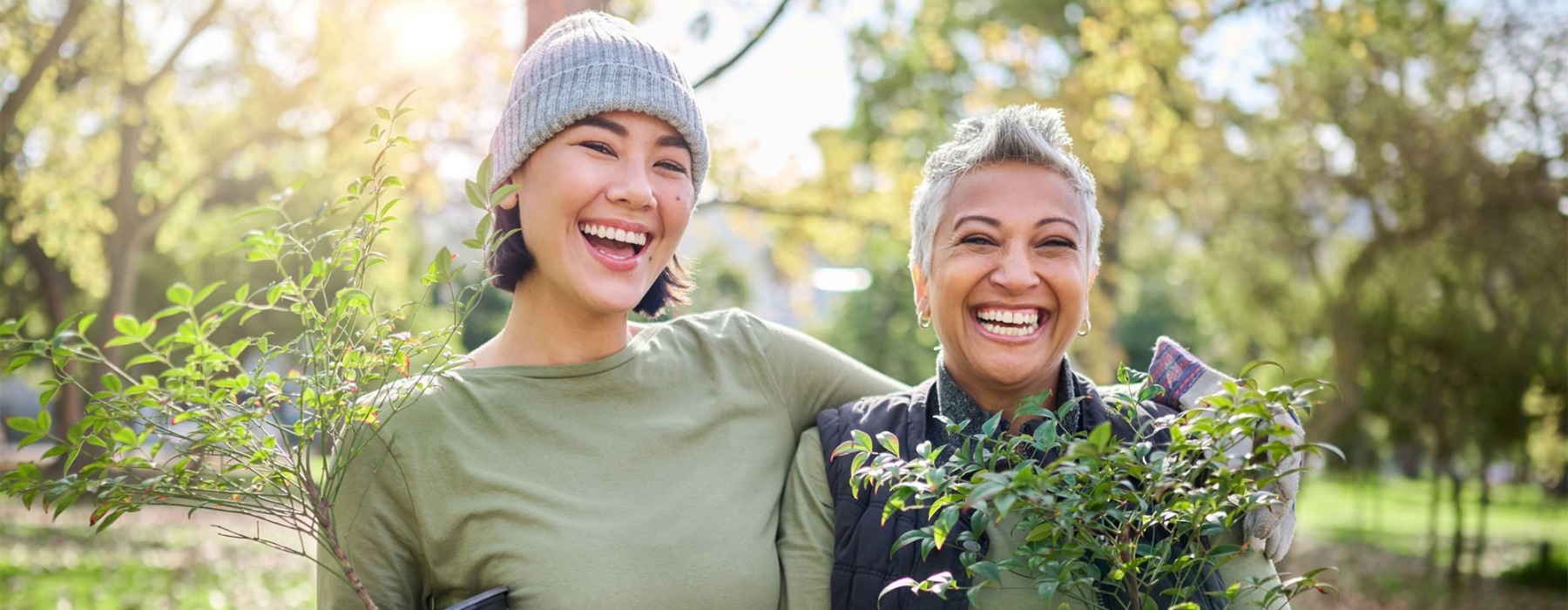 a couple of women holding plants